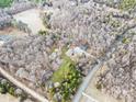 An aerial view of the property showing lush greenery and a serene pond at 10000 Blossom Dr, Concord, NC 28025