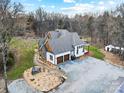 Aerial view of a home featuring an attached two-car garage and a spacious gravel driveway at 10000 Blossom Dr, Concord, NC 28025