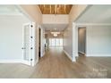 Spacious foyer showcases hardwood floors, high ceilings, and access to various rooms, offering a seamless flow throughout the home at 102 Pecan Cove Ln, Weddington, NC 28104