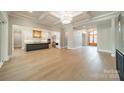 Open-concept living room with a view of the modern kitchen island and stylish lighting, perfect for entertaining and Gathering gatherings at 102 Pecan Cove Ln, Weddington, NC 28104