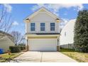 Charming two-story home showcasing a garage and a well-maintained yard at 1021 Joselynn Dr, Gastonia, NC 28054