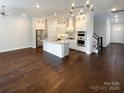 Open-concept living space featuring a gourmet kitchen and gleaming hardwood floors at 11005 Cobb Creek Ct, Charlotte, NC 28277
