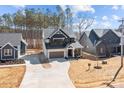 Wide shot of a modern home showcasing professional landscaping and an extended driveway at 119 Mills Garden Rd, Statesville, NC 28625