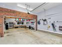Spacious garage featuring exposed brick, ample storage space, overhead lighting and a clean concrete floor at 126 Anchor Ln, Troutman, NC 28166