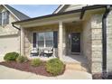 Charming front porch with stylish seating and a welcoming entrance with a wreath at 12889 Hill Pine Rd, Midland, NC 28107