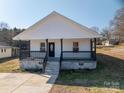 Charming home featuring a inviting front porch with black railings, perfect for enjoying the outdoors at 1411 Roseland Dr, Lincolnton, NC 28092