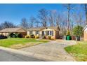 Charming house with a manicured front yard and paved driveway at 1438 Plumstead Rd, Charlotte, NC 28216