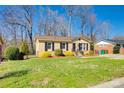 This beautiful home boasts lush green grass, manicured shrubs, and mature trees at 1438 Plumstead Rd, Charlotte, NC 28216