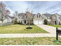Beautiful two-story home with well-maintained lawn and driveway leading to the garage at 1580 Duckhorn Nw St, Concord, NC 28027