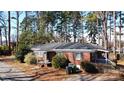 Well-maintained brick home with mature landscaping, charming shutters, and a cozy front porch at 1738 Matheson Ave, Charlotte, NC 28205