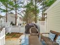 Cozy back patio with grill, and a white picket fence at 1752 Hidden Creek Dr, Rock Hill, SC 29732