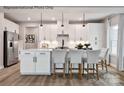 Modern kitchen featuring stainless steel appliances, a kitchen island with bar seating and sleek white cabinetry at 1805 Ab Moore Jr Dr # 3237, Indian Trail, NC 28079