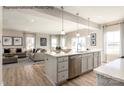 An open-concept kitchen boasts stainless steel appliances, an island with a sink, and seamless flow into the living area at 1805 Ab Moore Jr Dr # 3237, Indian Trail, NC 28079