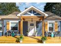 Close up of the entryway to this beautiful blue home with a bright, yellow porch at 2137 Highland St, Charlotte, NC 28208
