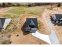 A high-angle view of a single-Gathering home with a large lawn and driveway on a sunny day at 4085 Miller Rd, Salisbury, NC 28147