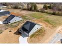 A high-angle view of a single-Gathering home with a large lawn and driveway on a sunny day at 4085 Miller Rd, Salisbury, NC 28147
