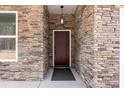 Stylish front door with stone trim and a hanging light fixture create a welcoming entrance to the home at 4085 Miller Rd, Salisbury, NC 28147