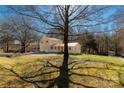 Sprawling property showcasing a home surrounded by lush greenery and mature trees under a blue sky at 4919 Rehobeth Rd, Waxhaw, NC 28173