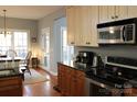Functional kitchen with stainless steel appliances, granite countertops, and hardwood floors at 522 Sarazen Way, Salisbury, NC 28144