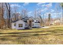 A serene view of the house, nestled on a sprawling lawn, perfect for Gathering gatherings and outdoor activities at 606 Saint Cloud Dr, Statesville, NC 28625