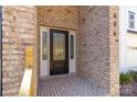 Elegant front door with glass panels and brick surround, providing a warm and inviting entrance at 606 Saint Cloud Dr, Statesville, NC 28625