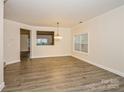 Bright living room featuring hardwood floors, crown molding and large windows at 6635 Ruth Ferrell Ct, Charlotte, NC 28269
