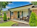 Inviting front porch with rocking chairs, complementing the classic brick exterior and landscaped yard at 905 Blalock Dr, Kings Mountain, NC 28086