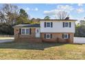 Charming two-story home with brick accents, black shutters, and a well-maintained front yard at 108 Donna Ave, Gastonia, NC 28052