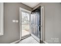 Inviting entryway featuring gray walls, plank flooring, and a glimpse of the front yard through the glass storm door at 113 Galilean Rd, York, SC 29745