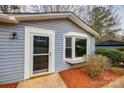 Welcoming entrance to a home with light gray siding, clean white trim, bay window and decorative mulch at 113 Galilean Rd, York, SC 29745