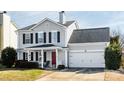 Charming two-story home with gray siding, black shutters, and a welcoming red front door at 11427 Lamoille Ln, Charlotte, NC 28278