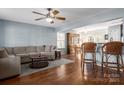 Bright and open living room area with hardwood floors, ceiling fan, and view to the dining area at 11427 Lamoille Ln, Charlotte, NC 28278