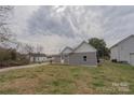 View of the home's backyard with a wooden deck and spacious lawn at 116 11Th St, Spencer, NC 28159
