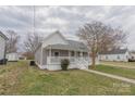 Charming single-story home with a covered front porch and manicured lawn at 116 11Th St, Spencer, NC 28159