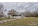 A charming home featuring a covered porch and a long driveway at 116 11Th St, Spencer, NC 28159