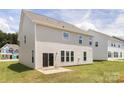 This image shows the back of the house, featuring a patio area and well-maintained backyard at 122 Asmodean Ln, Troutman, NC 28166
