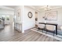 Bright dining area featuring modern decor, wainscotting, and hardwood floors, with an adjacent hall at 122 Asmodean Ln, Troutman, NC 28166