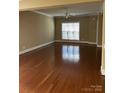 Open living room with ceiling fan, hardwood floors, and a neutral color palette at 1229 Mcgill Pond Ln, Rock Hill, SC 29732