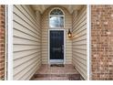 Front door with stone porch, sidelights, and house number at 12430 Kemerton Ln # 17, Huntersville, NC 28078