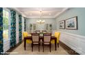 Beautiful dining room with tray ceilings, hardwood floors, and elegant chandelier at 126 Asmodean Ln, Troutman, NC 28166