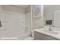 Well-lit bathroom with a clean white tub-shower combo, vanity, and modern sink at 128 Asmodean Ln, Troutman, NC 28166