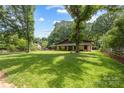 Picturesque view of the home nestled amidst a lush, green landscape at 13124 Lemmond Dr, Matthews, NC 28105