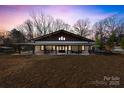 Charming home with a wide porch and a sunset sky at 13124 Lemmond Dr, Matthews, NC 28105