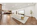 Open concept living room boasts hardwood floors and a projector screen at 13124 Lemmond Dr, Matthews, NC 28105