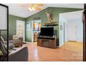 Cozy living room featuring an entertainment center and views into the kitchen at 1345 Beagle Run, Salisbury, NC 28146