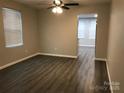 Cozy living room with wood floors, ceiling fan, and view to additional rooms at 1404 Lineberger Ave, Gastonia, NC 28052