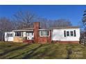 Traditional single-story home with a brick chimney, contrasting white siding, and a neatly kept lawn at 1426 E Council St, Salisbury, NC 28146