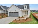 Beautiful single-Gathering home with a grey garage door, well-kept landscaping, and covered entry at 1529 Pebble Shore Ln # 164, Belmont, NC 28012
