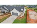 Beautiful single-Gathering home with a grey garage door, new landscaping, and manicured lawn at 1529 Pebble Shore Ln # 164, Belmont, NC 28012