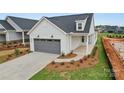 Charming single-Gathering home with a grey garage door and an inviting front exterior in a new neighborhood at 1529 Pebble Shore Ln # 164, Belmont, NC 28012